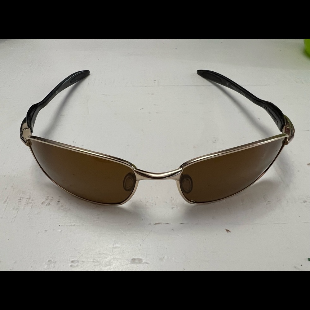 Oakley Blender sunglasses. Gold and black frames and gold lenses.